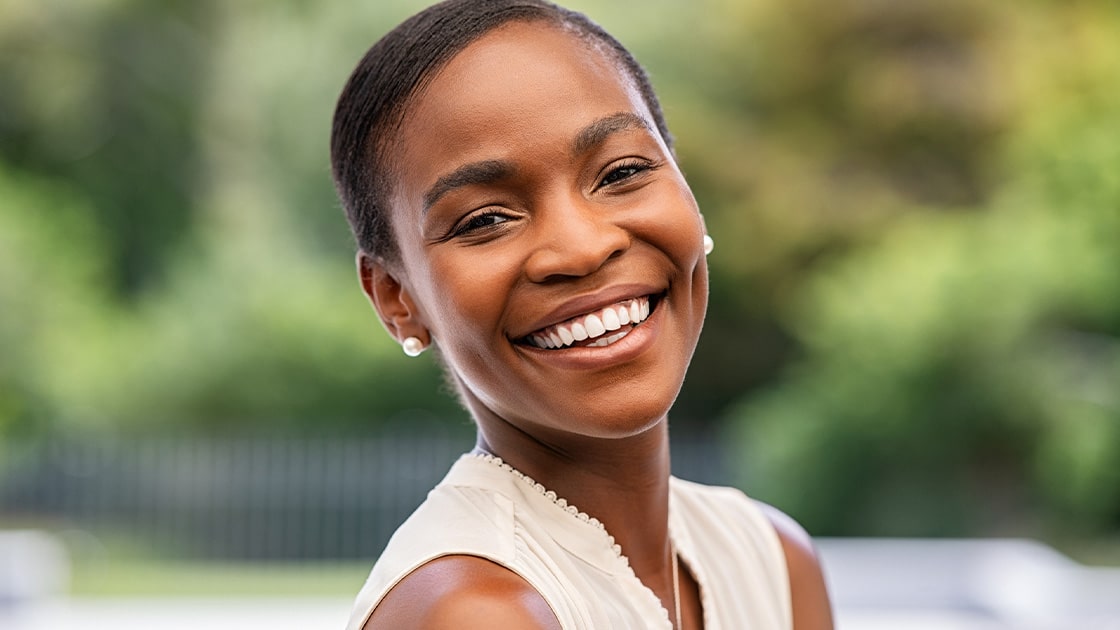 Patient smiling after same-day crown restoration
